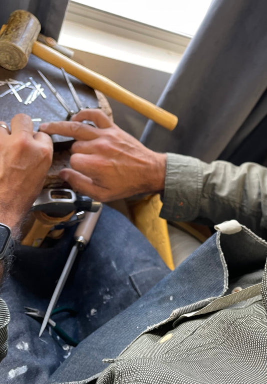 silversmith artist Caleb Calles working on a piece of sterling silver jewelry