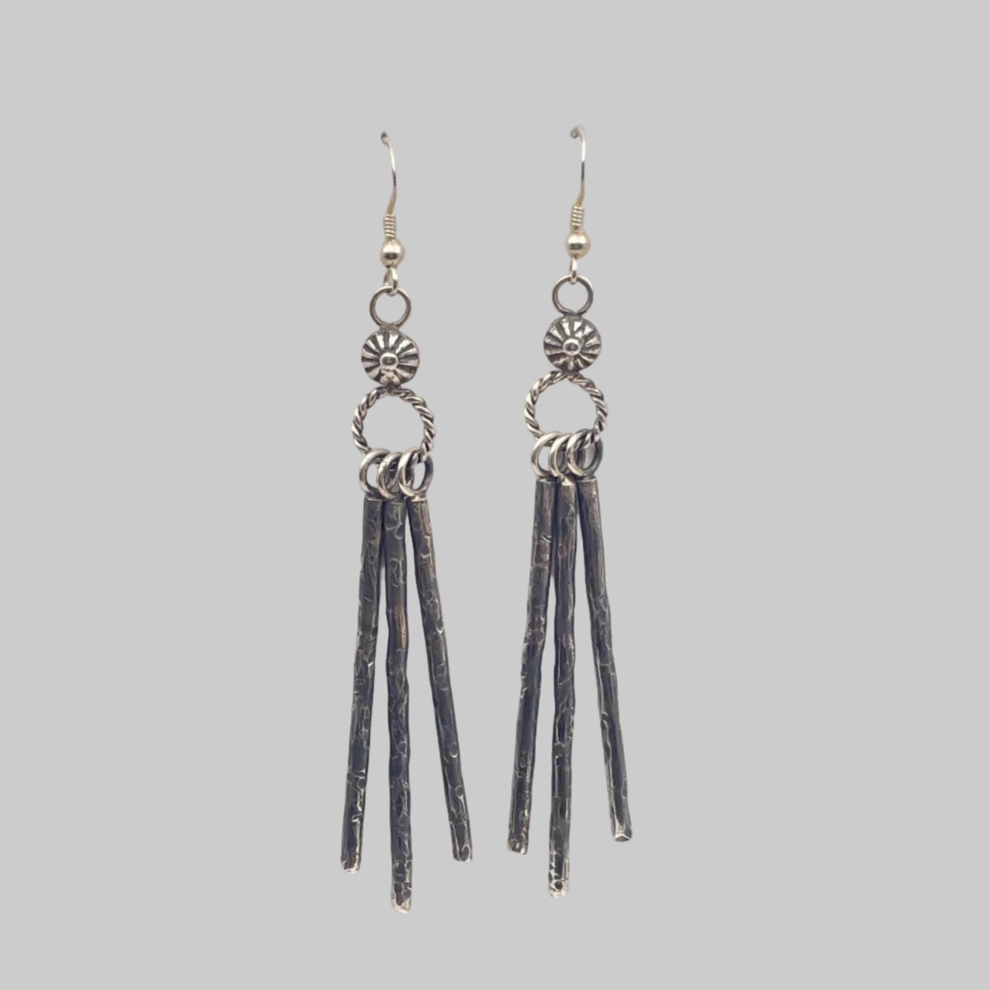 A Pair of Sterling silver earrings with hand stamped details on French hooks