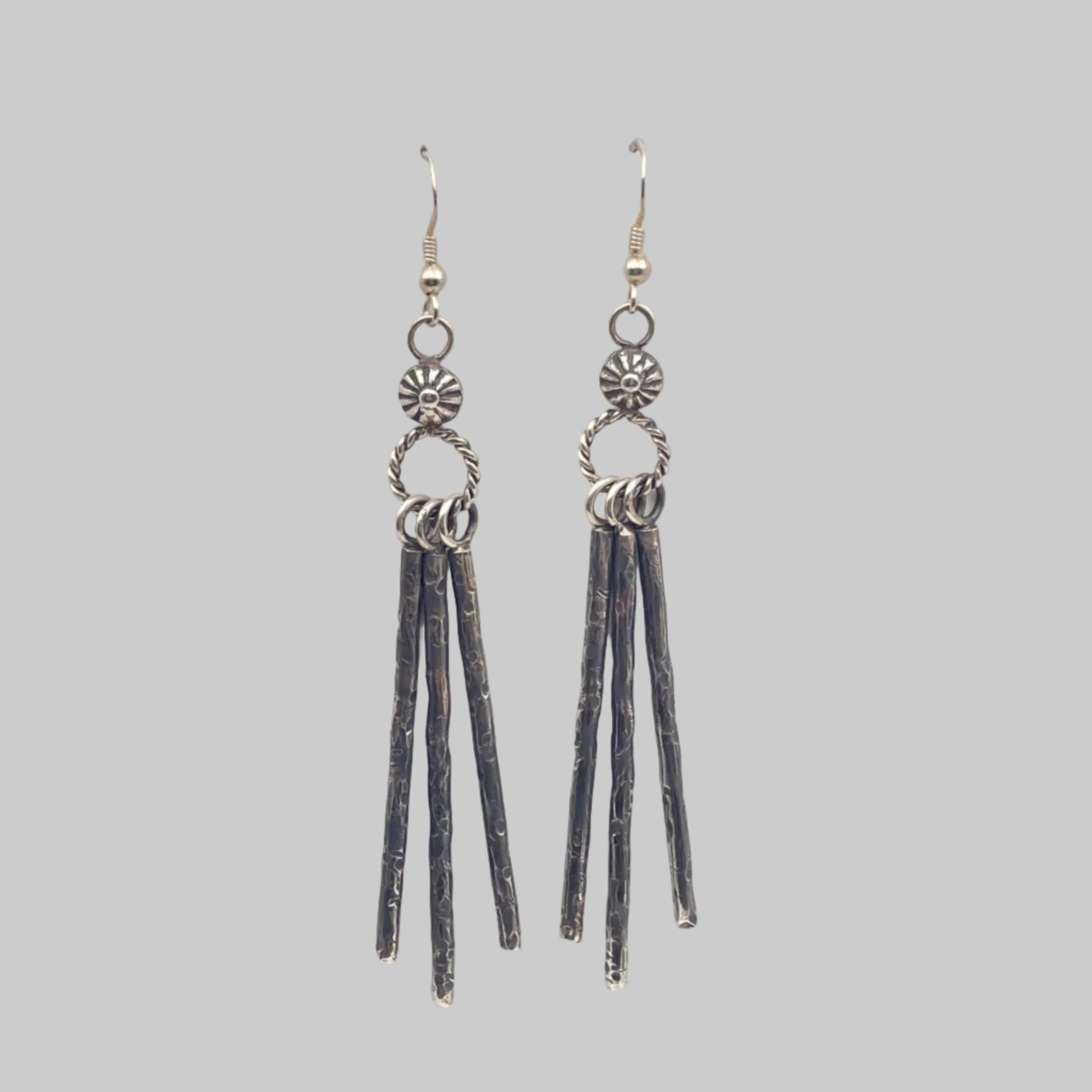A Pair of Sterling silver earrings with hand stamped details on French hooks