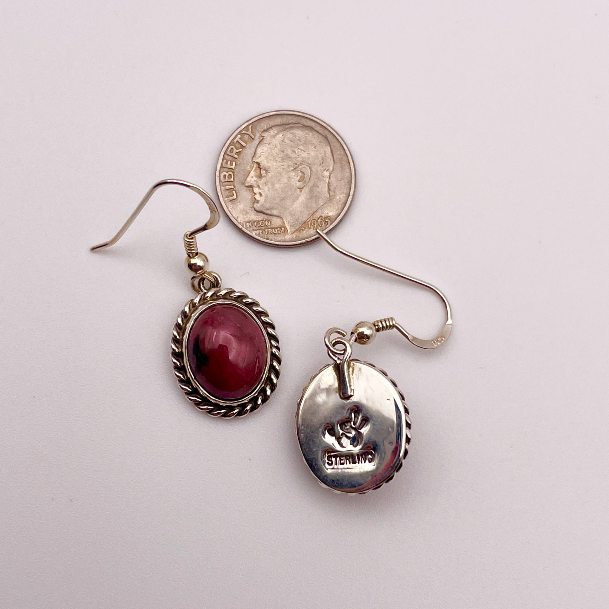 Sterling silver French hook earrings set with rhodonite stones front and back view of artist stamp shown with a dime for scale