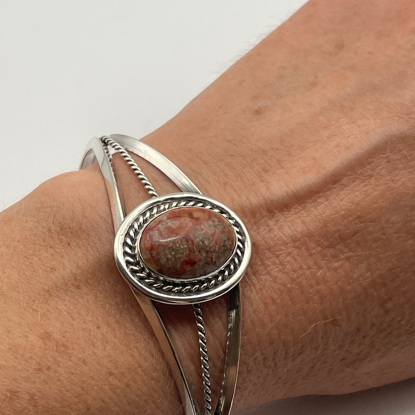 Natural stone cuff bracelet in sterling silver worn on wrist