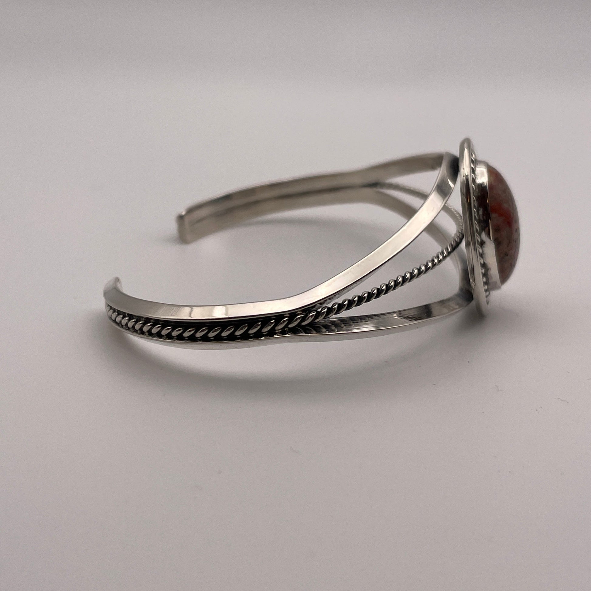 Side view of sterling silver cuff bracelet with triangle wire design