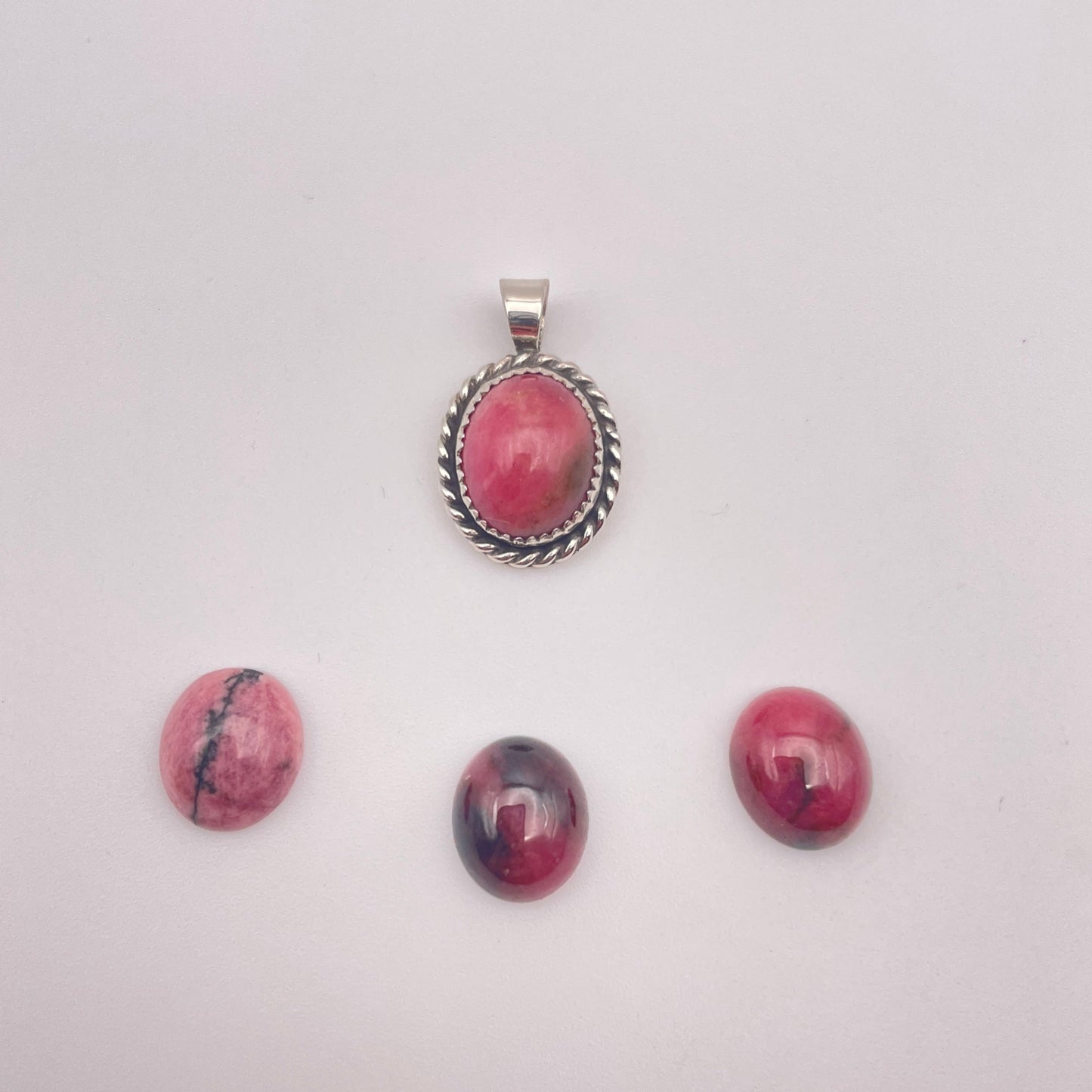 rhodonite stone set in handmade sterling silver pendant with three alternate rhodonite stones show