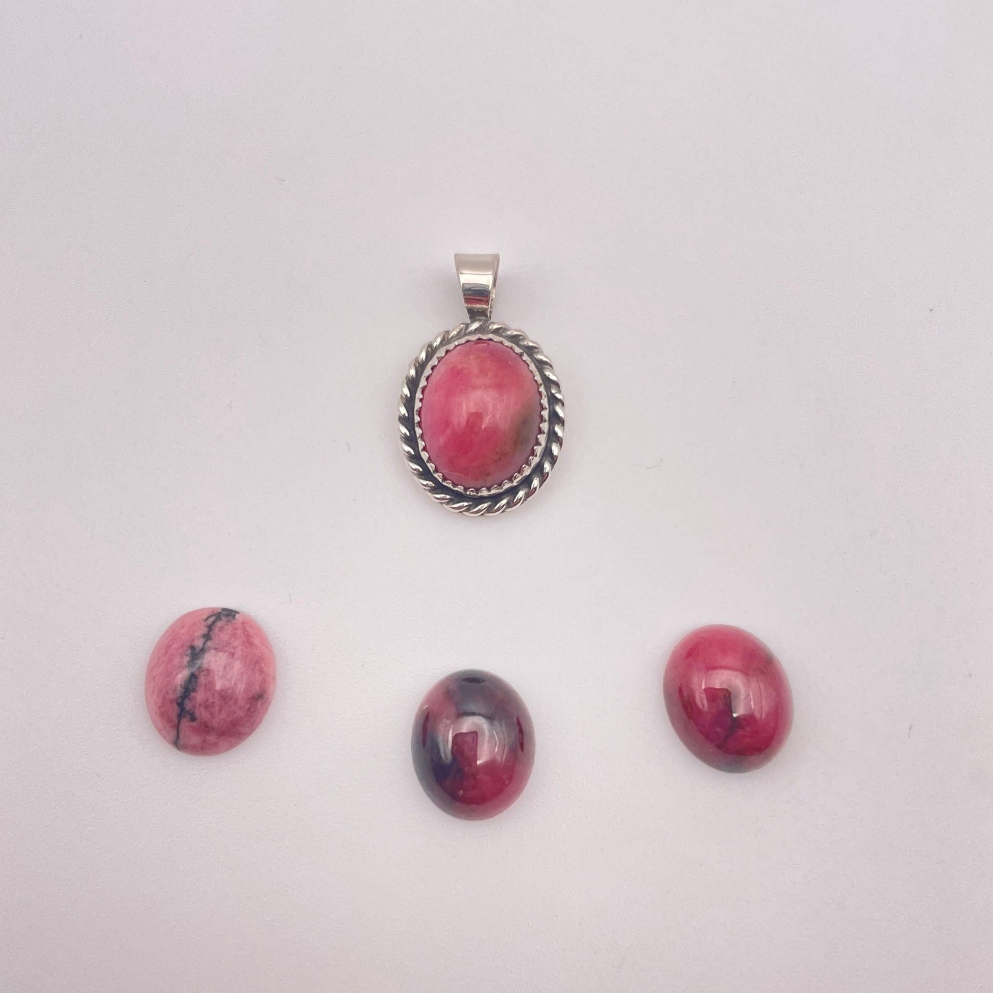 rhodonite stone set in handmade sterling silver pendant with three alternate rhodonite stones show