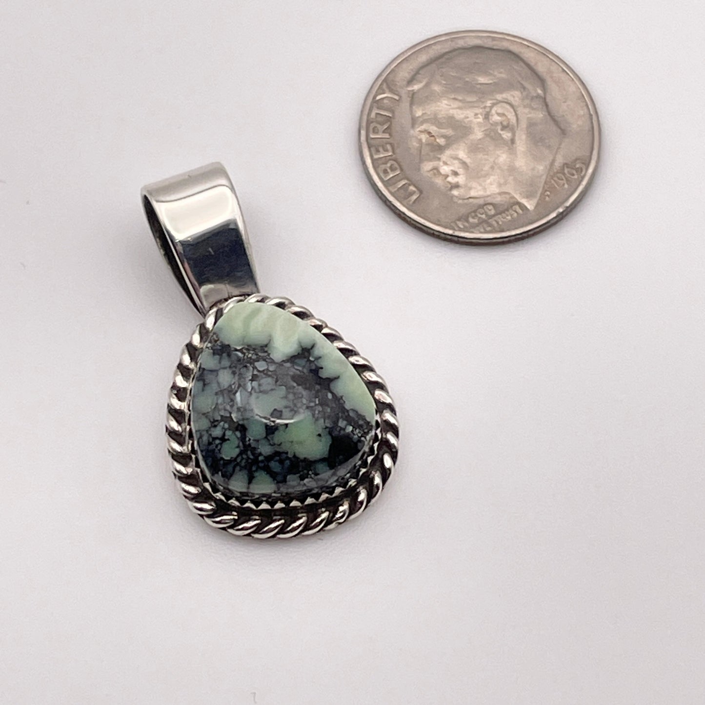 Poseidon Variscite stone pendant set in Sterling Silver shown with a dime for size comparison. 