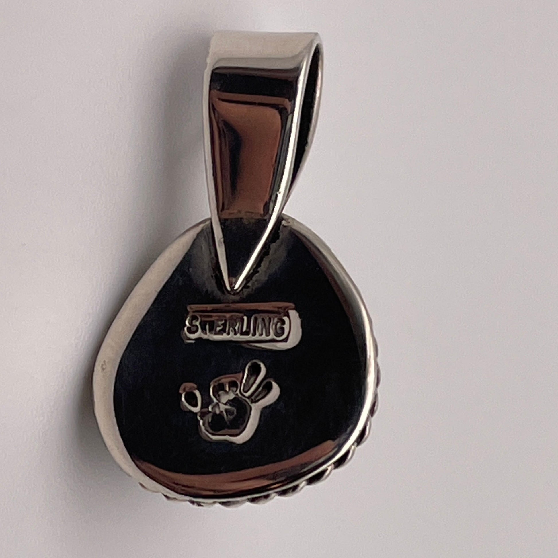 the reverse side of a Poseidon Variscite stone pendant set in Sterling Silver with Caleb Calles' exclusive artist's stamp and sterling stamp