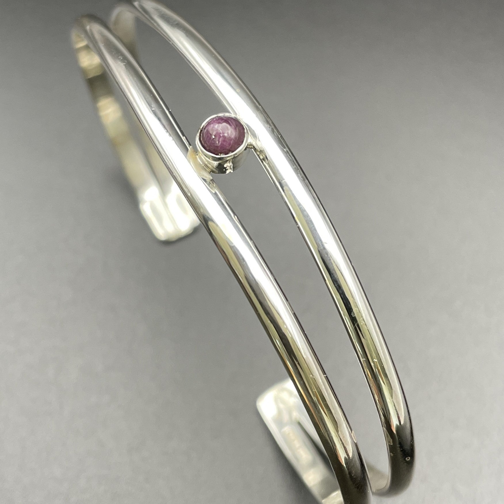 Sterling Silver cuff bracelet for ladies with July's birthstone, Ruby handmade by artist Caleb Calles owner of Broken Hand Creations