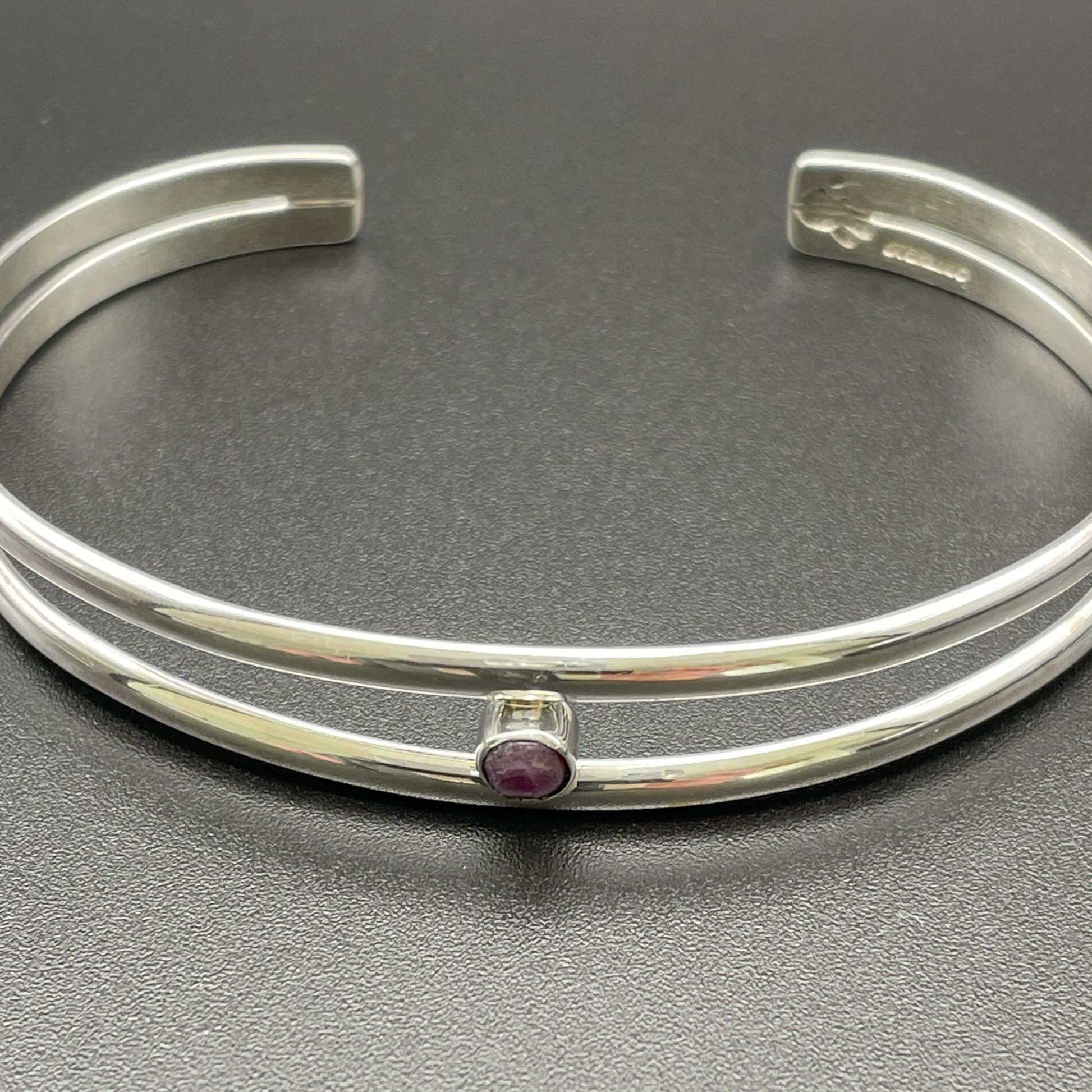 Sterling Silver ladies cuff bracelet handmade by Native Arizona Artist Caleb Calles of Broken Hand Creations featuring July birthstone a Ruby