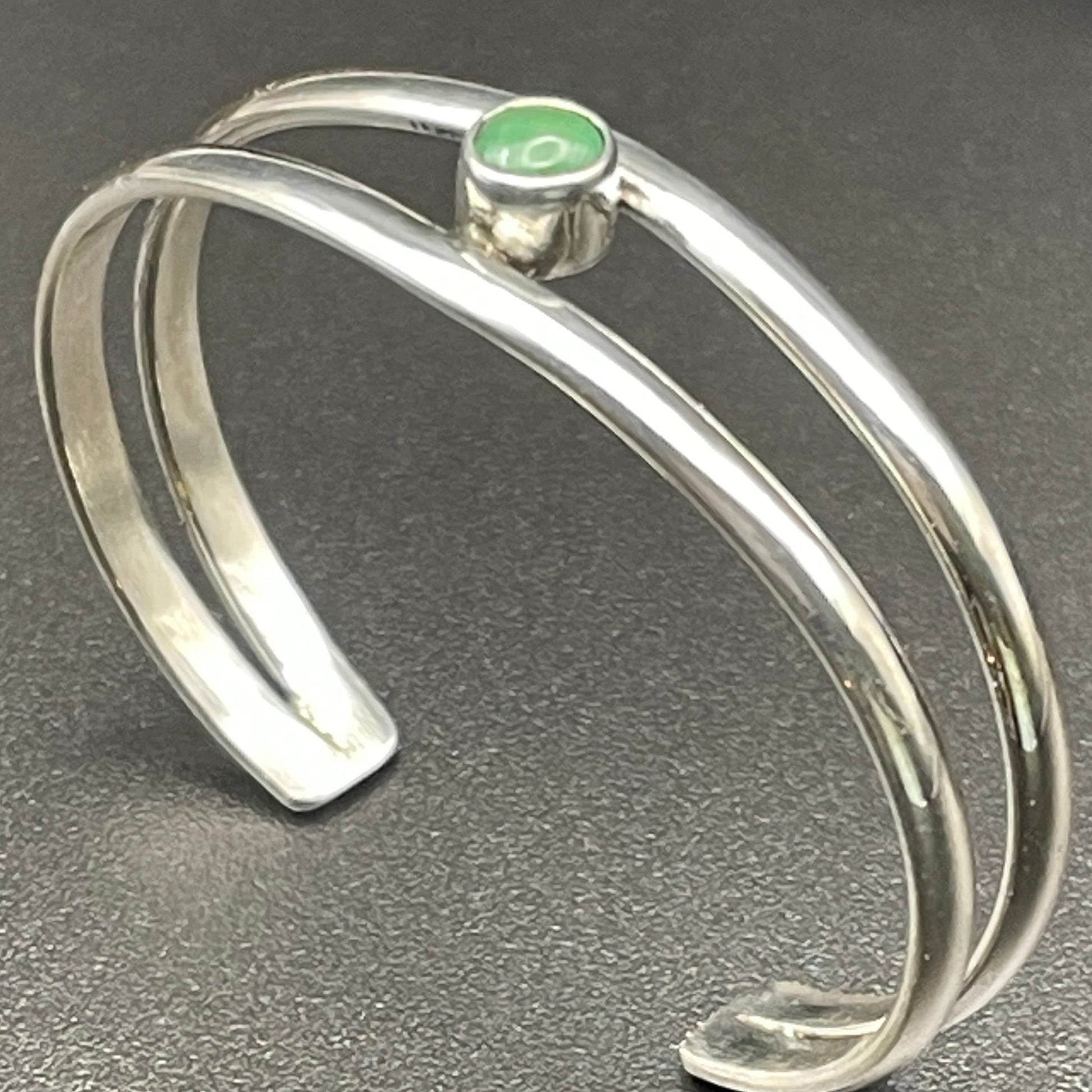 Sterling Silver baby keepsake bracelet featuring May's emerald by artist Caleb Calles