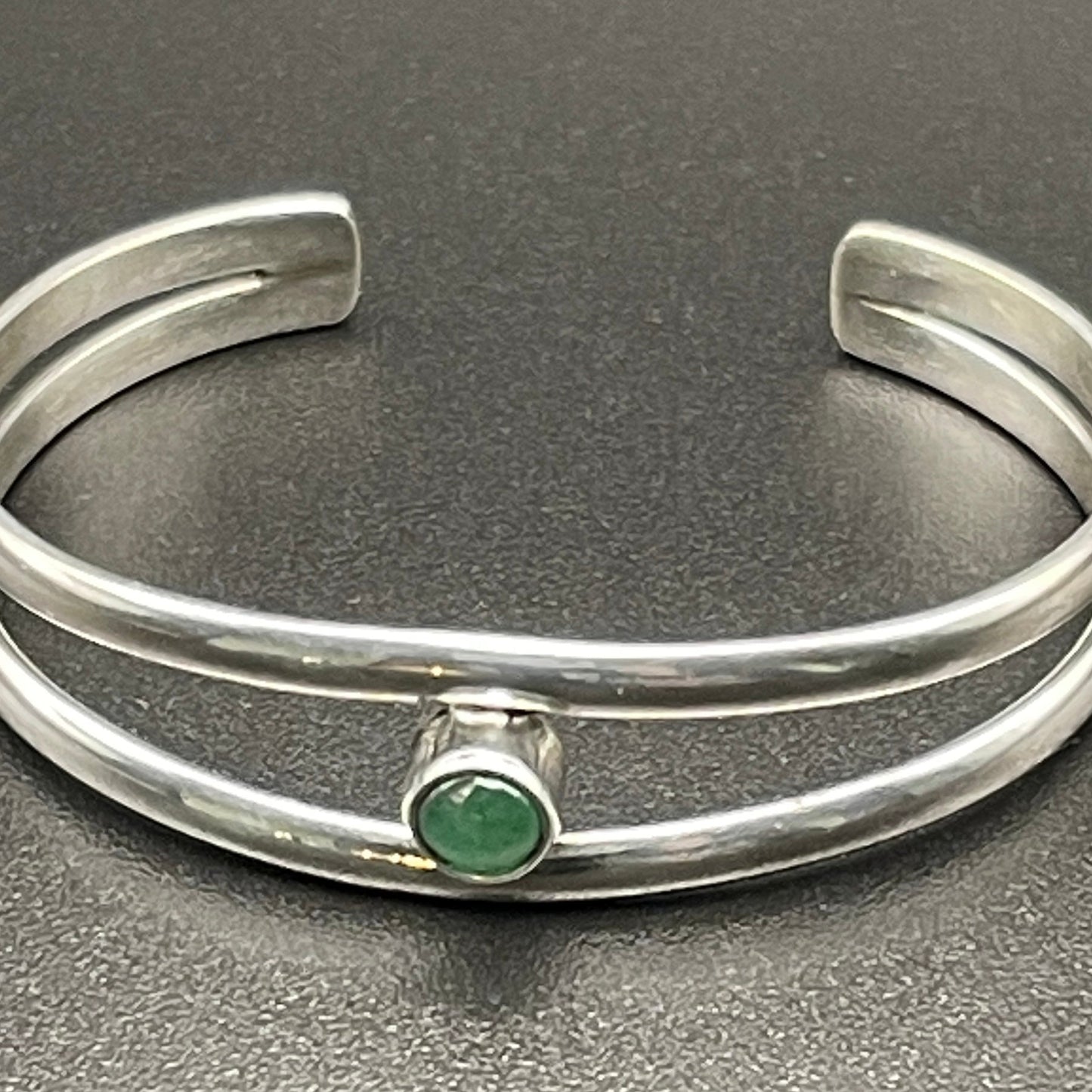 Sterling Silver baby bracelet featuring May's birthstone Emerald by artist Caleb Calles