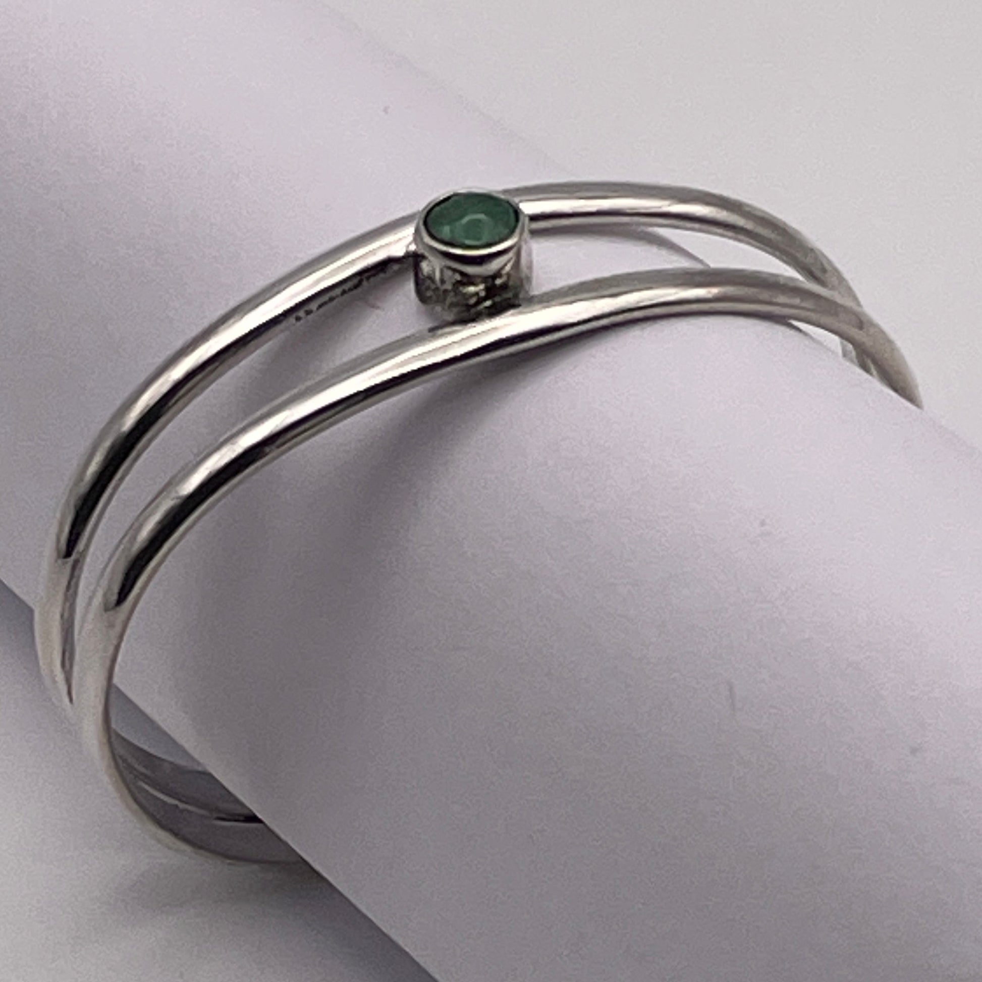 Sterling Silver baby bracelet featuring a genuine birthstone handmade by artist Caleb Calles